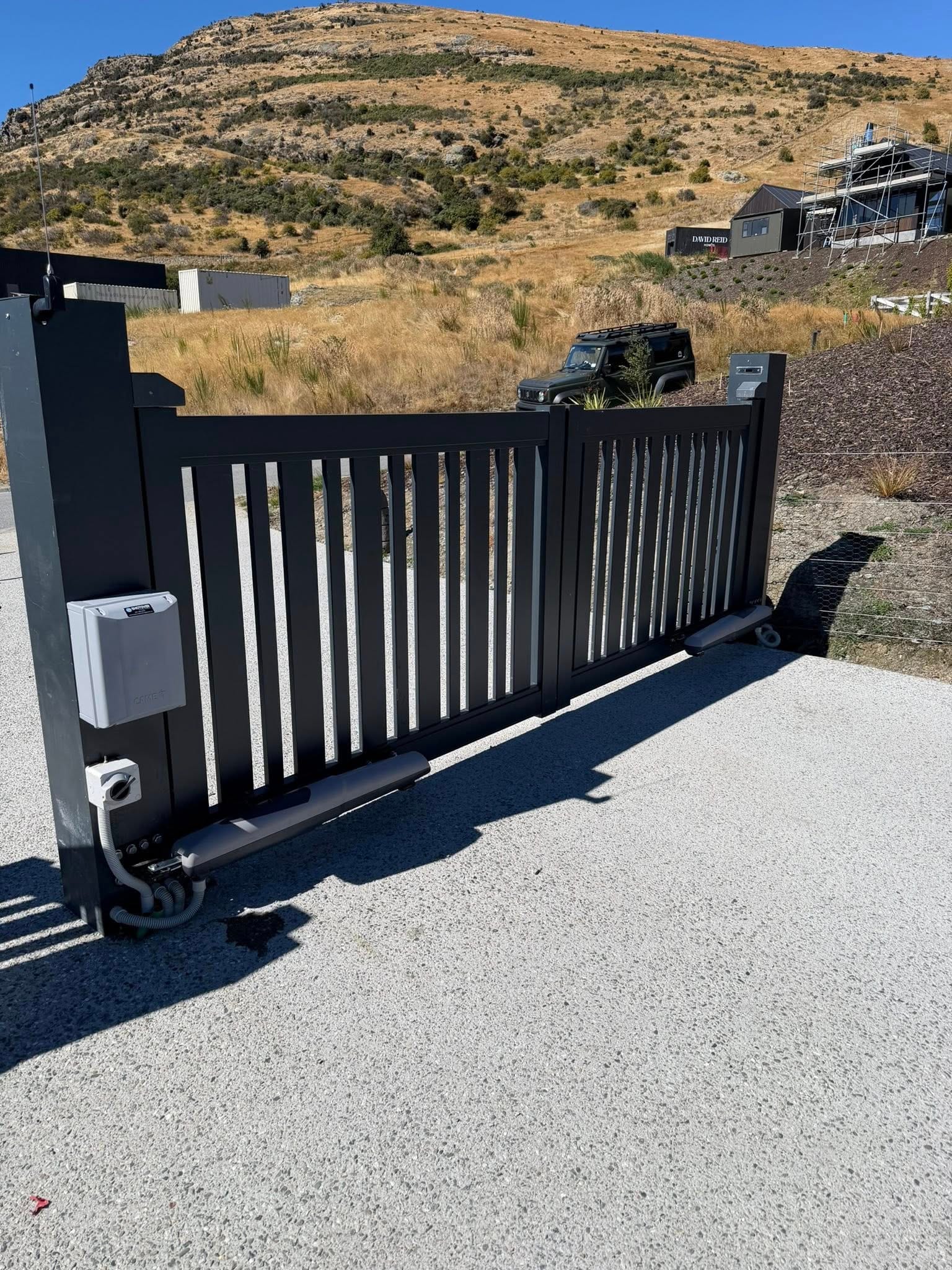 Sliding automatic gate close-up showing motor mechanism