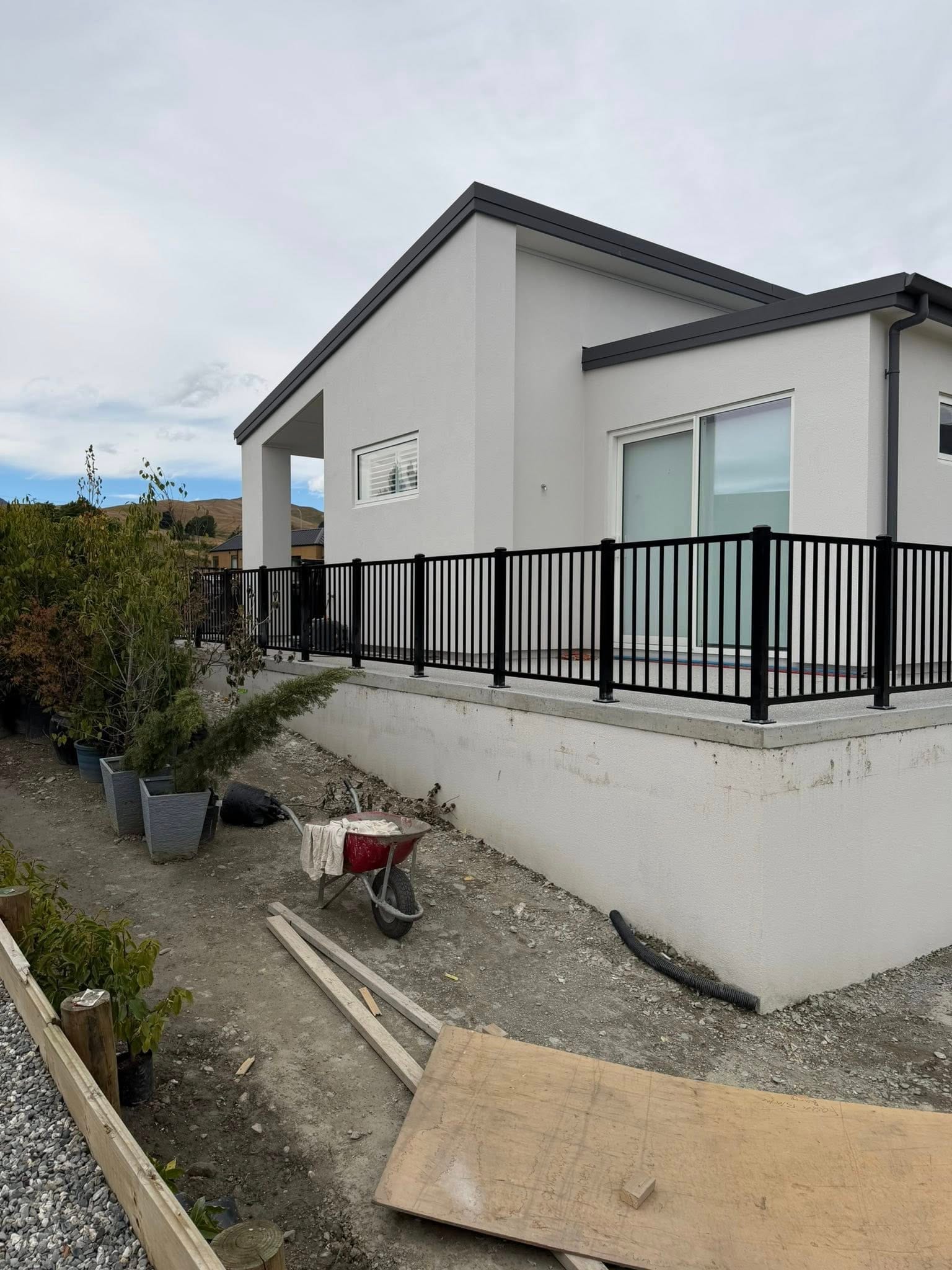Black tubular steel balustrade on a new residential home overlooking the garden, Queenstown