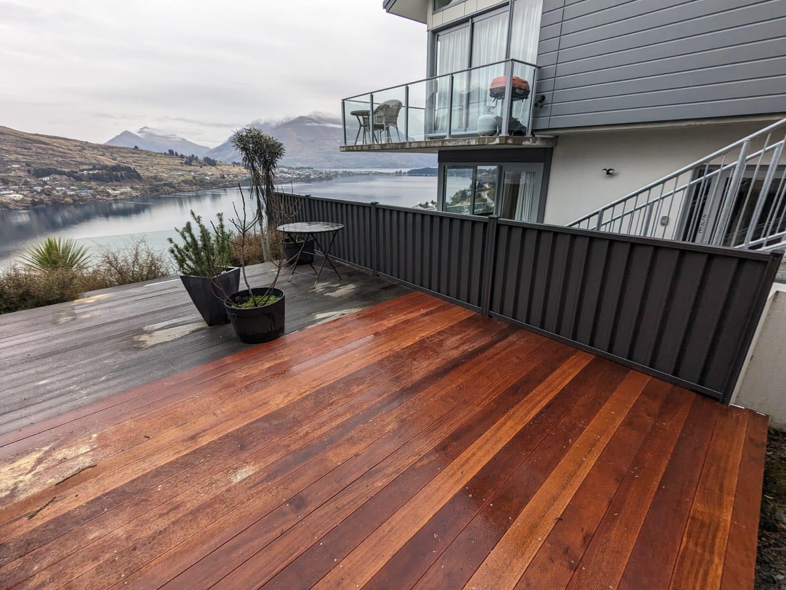 Timber deck with Colorsteel privacy fence overlooking Lake Wakatipu and mountains, Queenstown