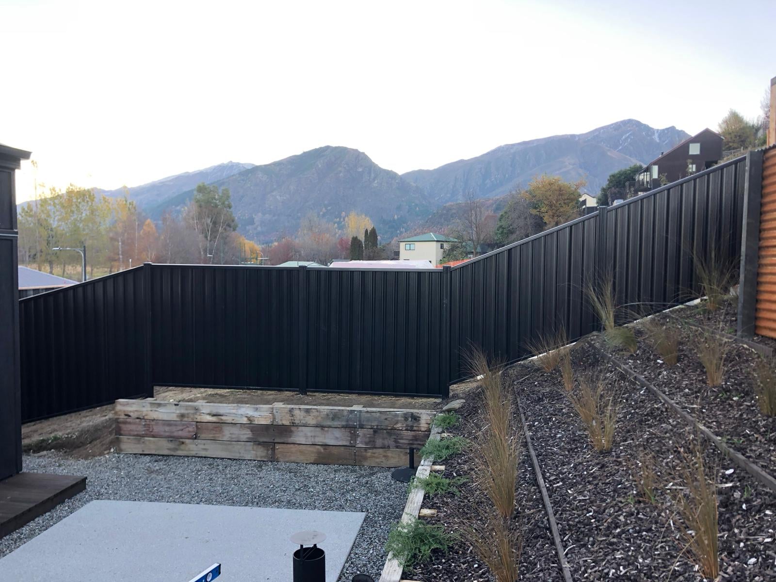 Dark colour panel fencing with autumn mountain views, Queenstown