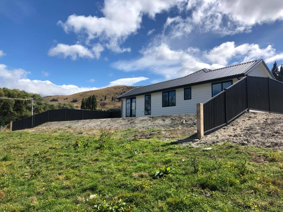 Colour panel fencing on a hillside new home, Queenstown