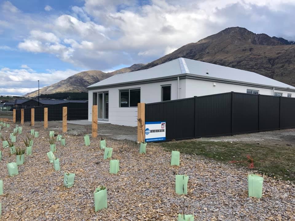 Colorsteel fencing on a new build with Shotover branding signage and snowy mountains behind, Queenstown