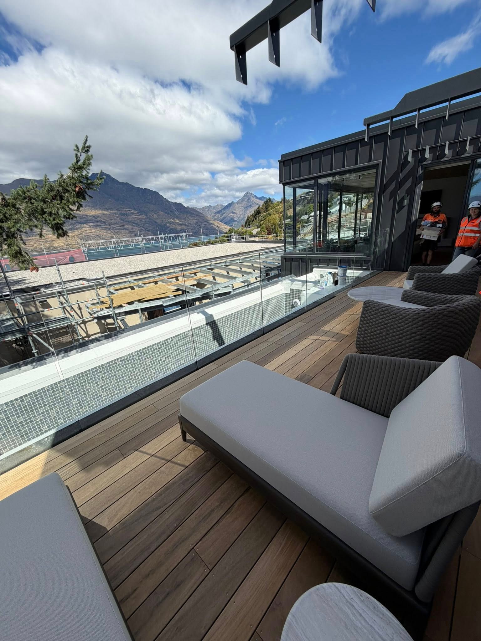 Composite deck with outdoor furniture and glass balustrade