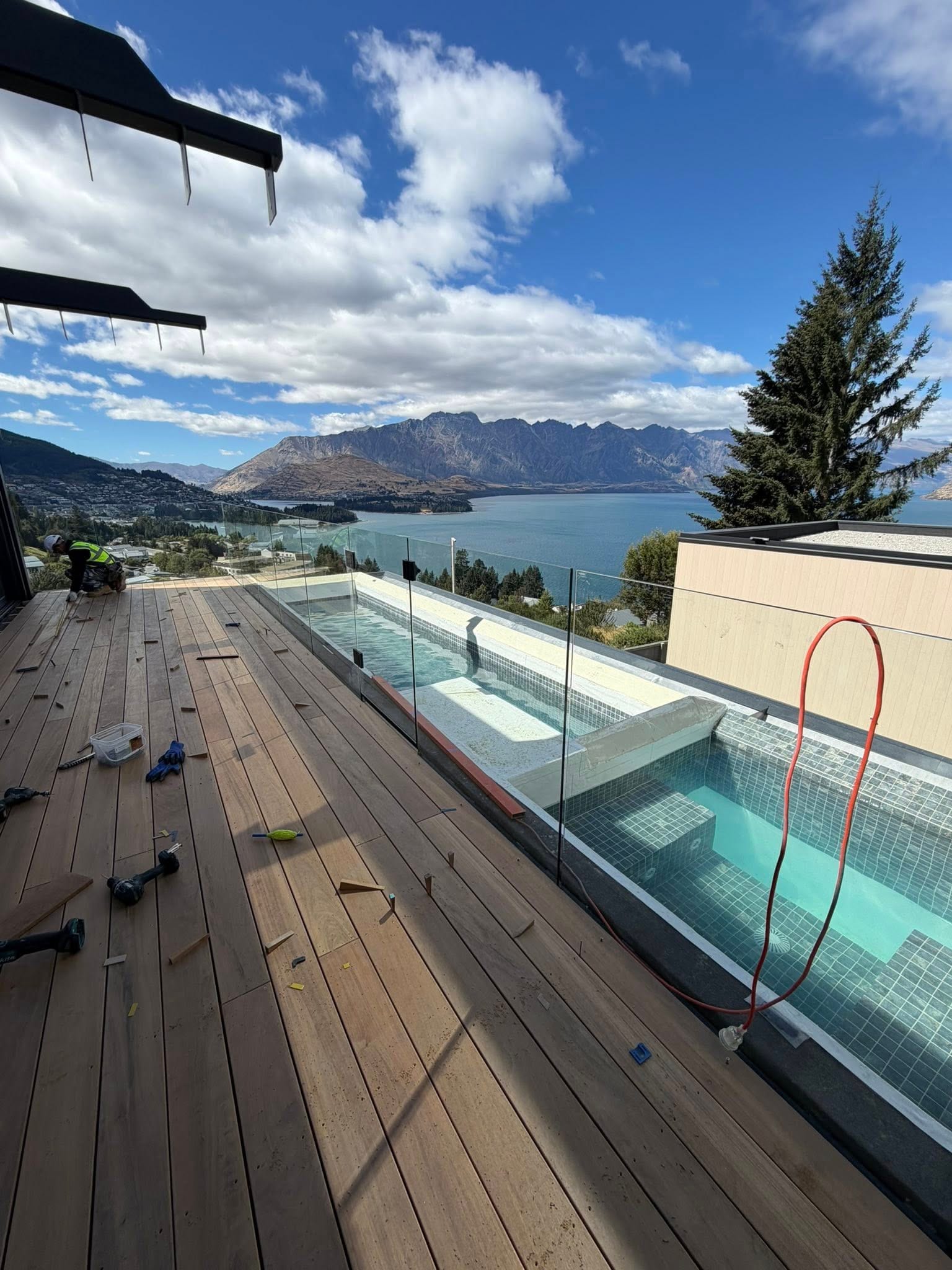 Deck with frameless glass balustrade and pool view