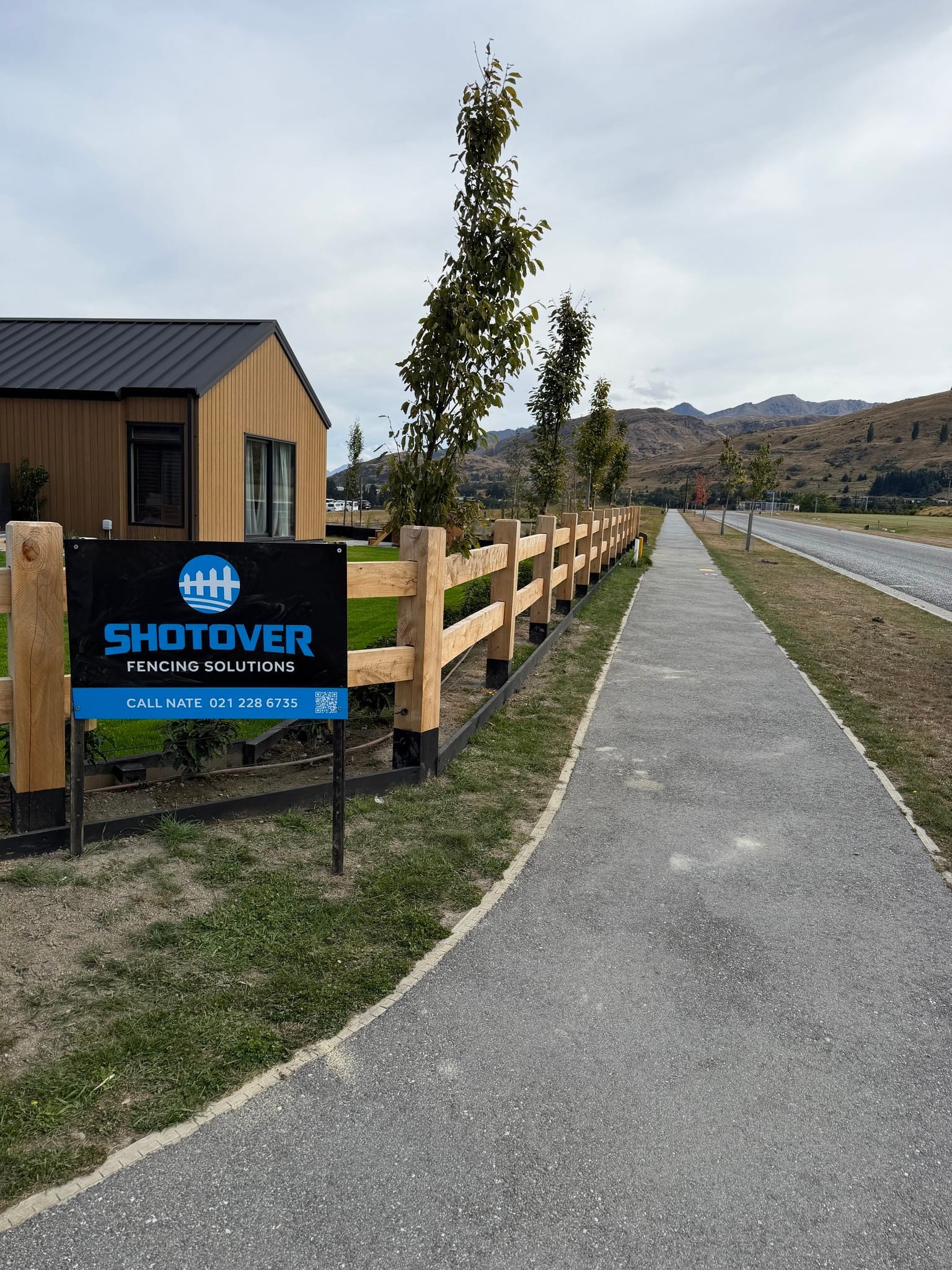 Macrocarpa fencing with subdivision signage at Hanley's Farm, Queenstown