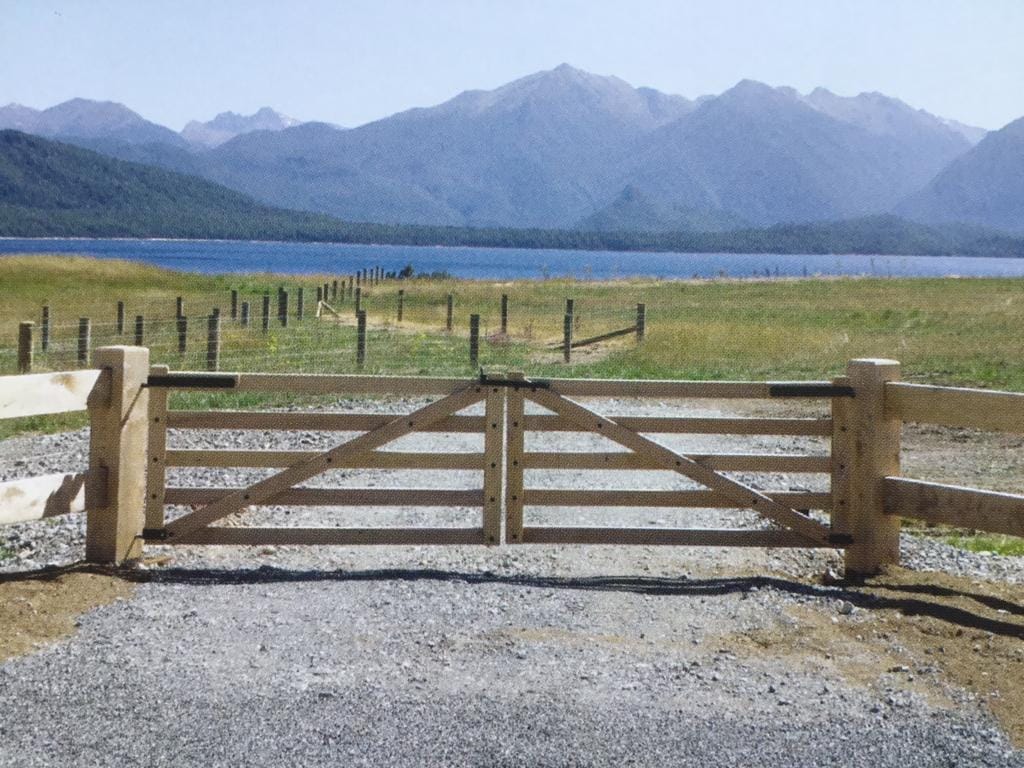 Rural macrocarpa gate with Lake Wakatipu and mountain views