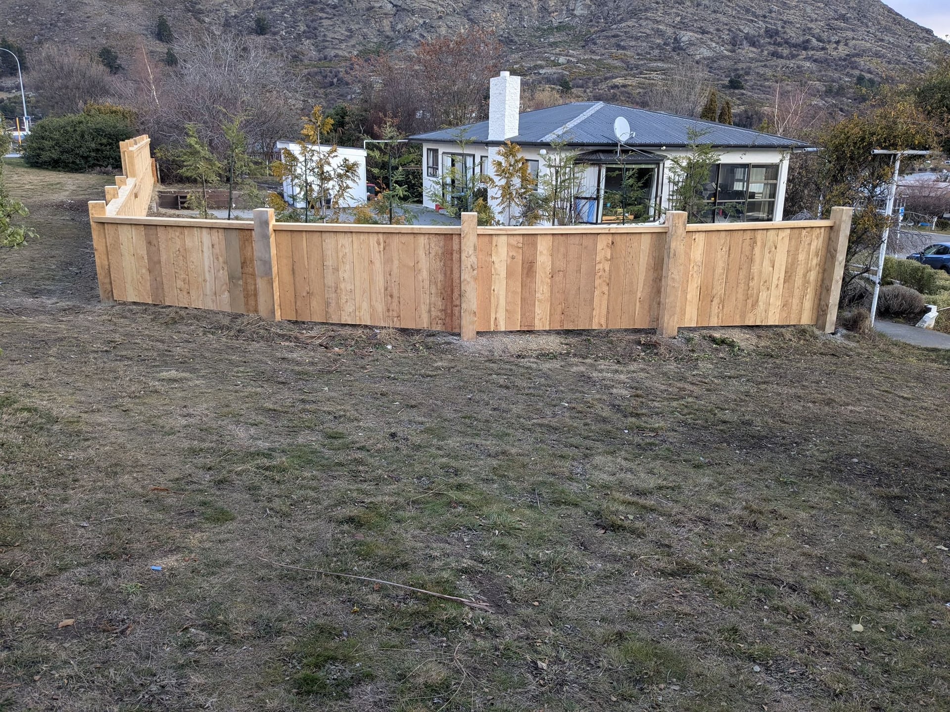 Pine paling fence wrapping around a Queenstown hillside property