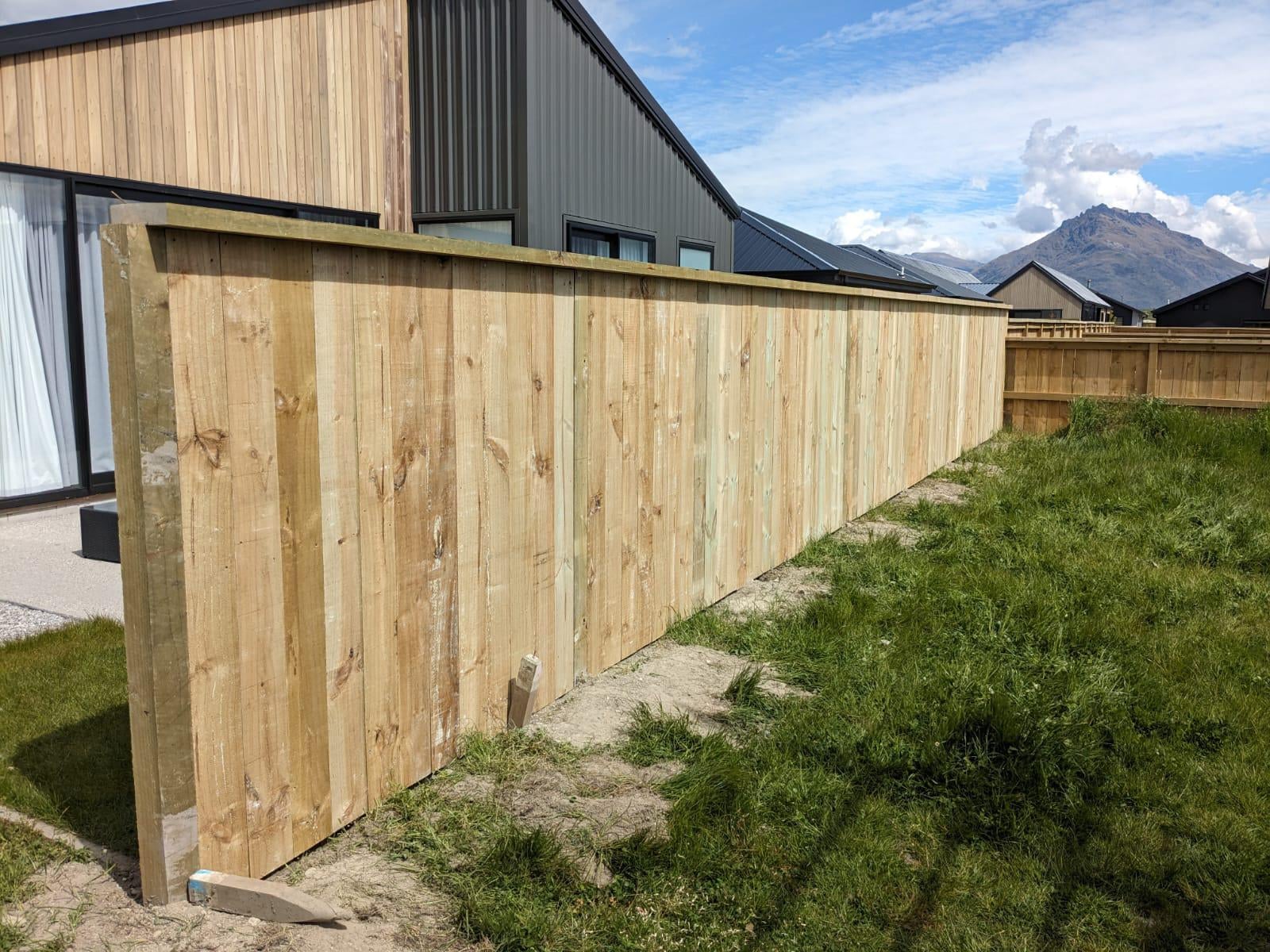 Pine paling fence beside a new build home, Queenstown