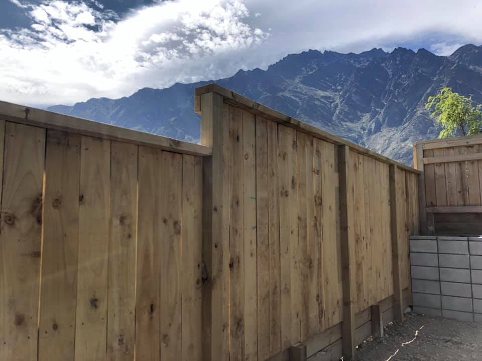 Close-up of pine paling fence with The Remarkables in the background, Queenstown