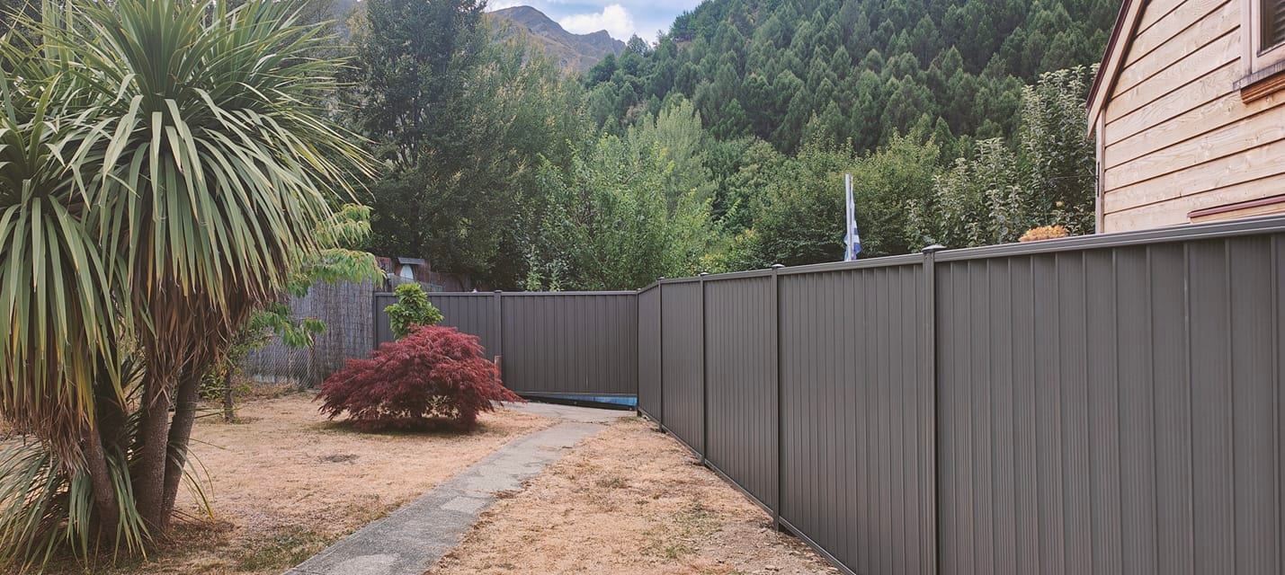 Grey composite residential fencing with mountain backdrop