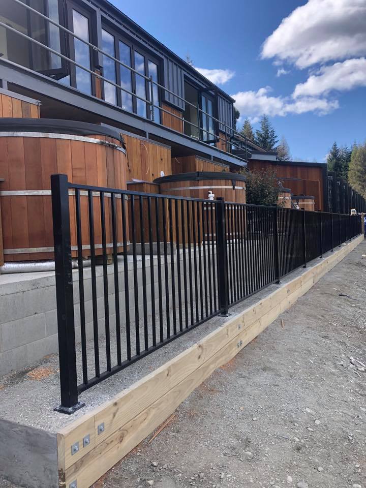 Steel pool fencing with timber sleeper retaining wall, Queenstown