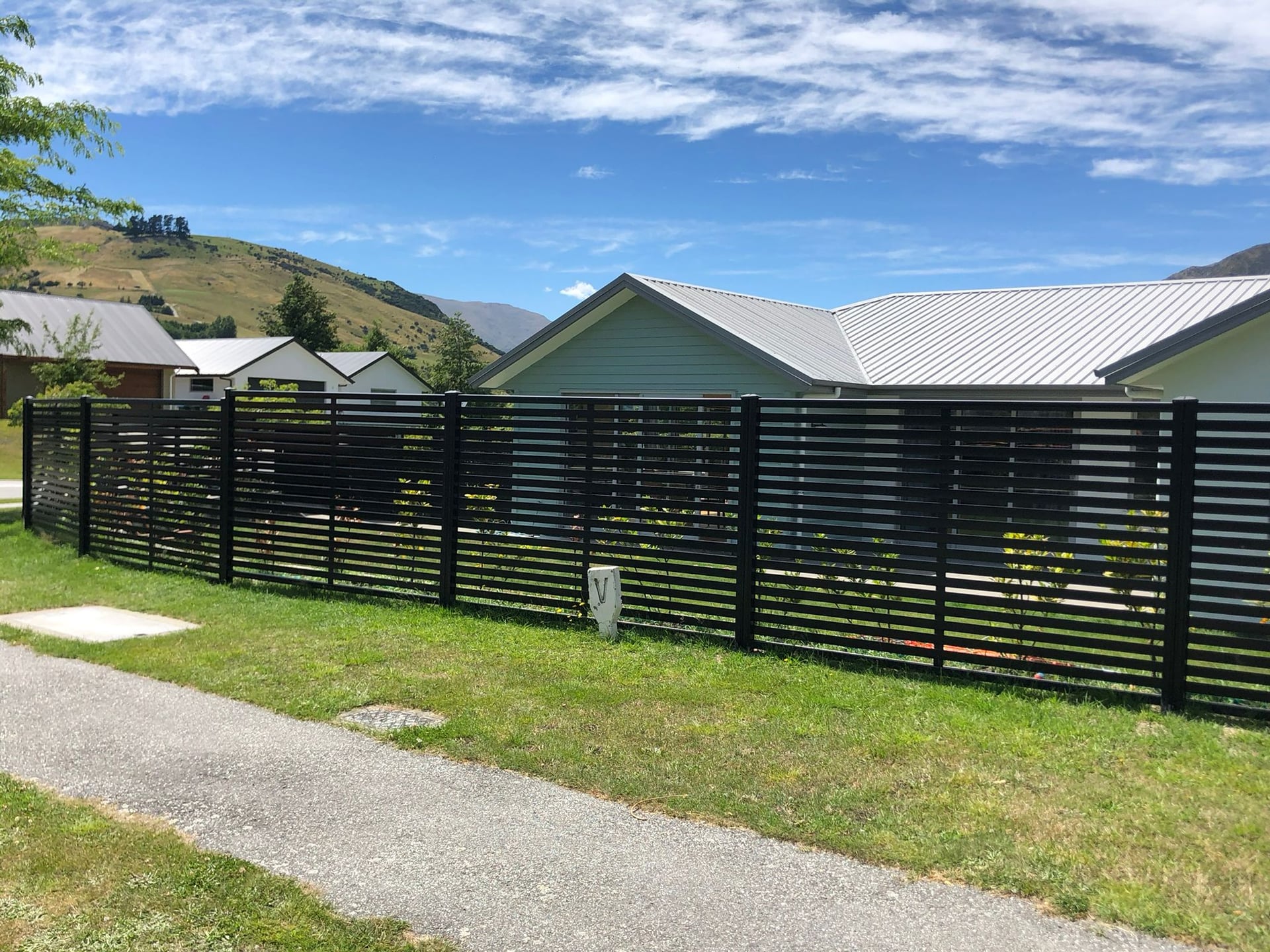 Dark horizontal slat fence on a residential property, Queenstown