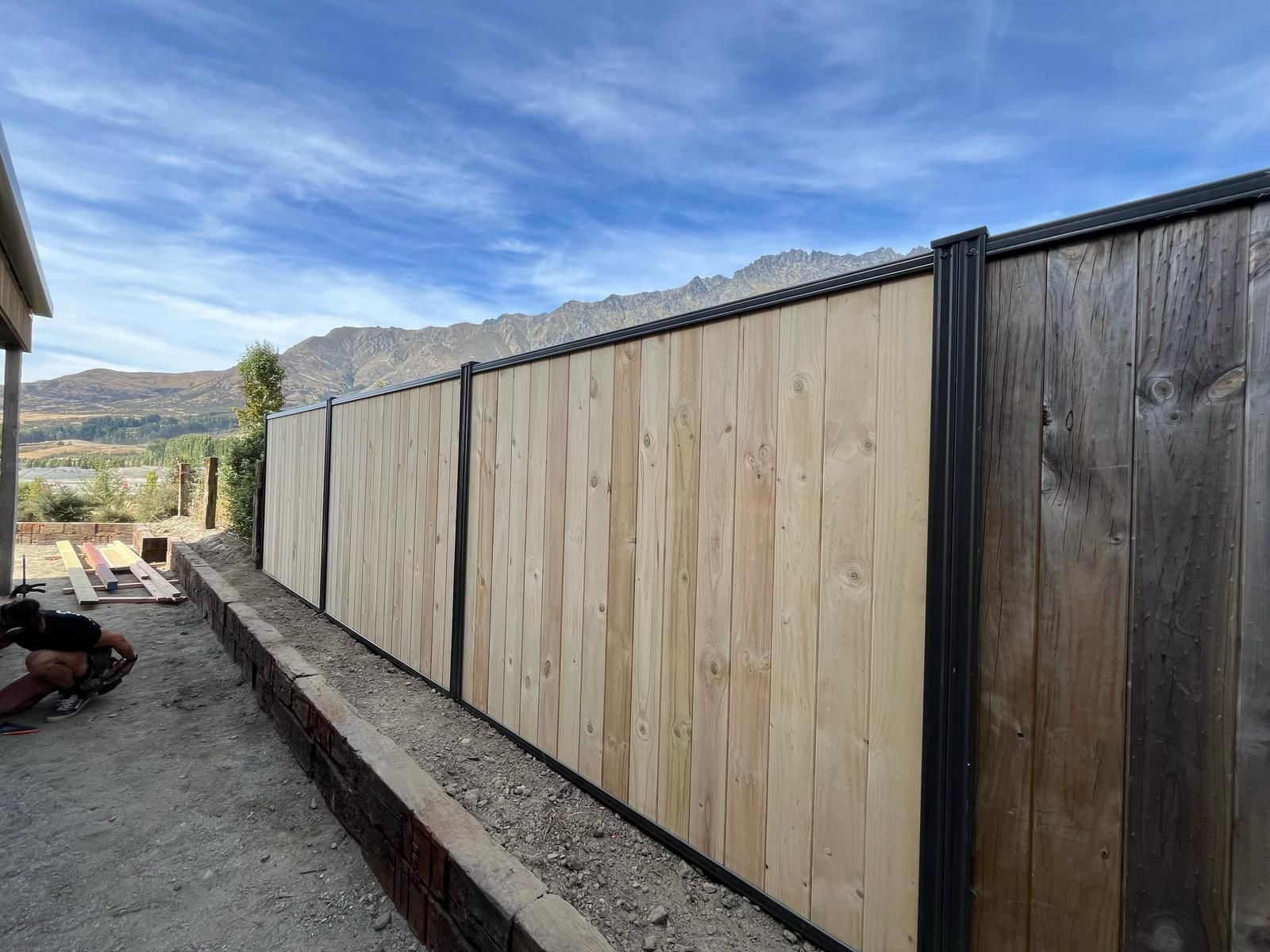 Cedar Smartwall privacy fencing being installed with The Remarkables in the background, Queenstown